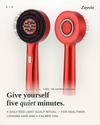 A red handheld scalp massager shown from two angles on a light cream background, with promotional text reading 'Give yourself five quiet minutes.' and the brand name Zayvio at the top right.
